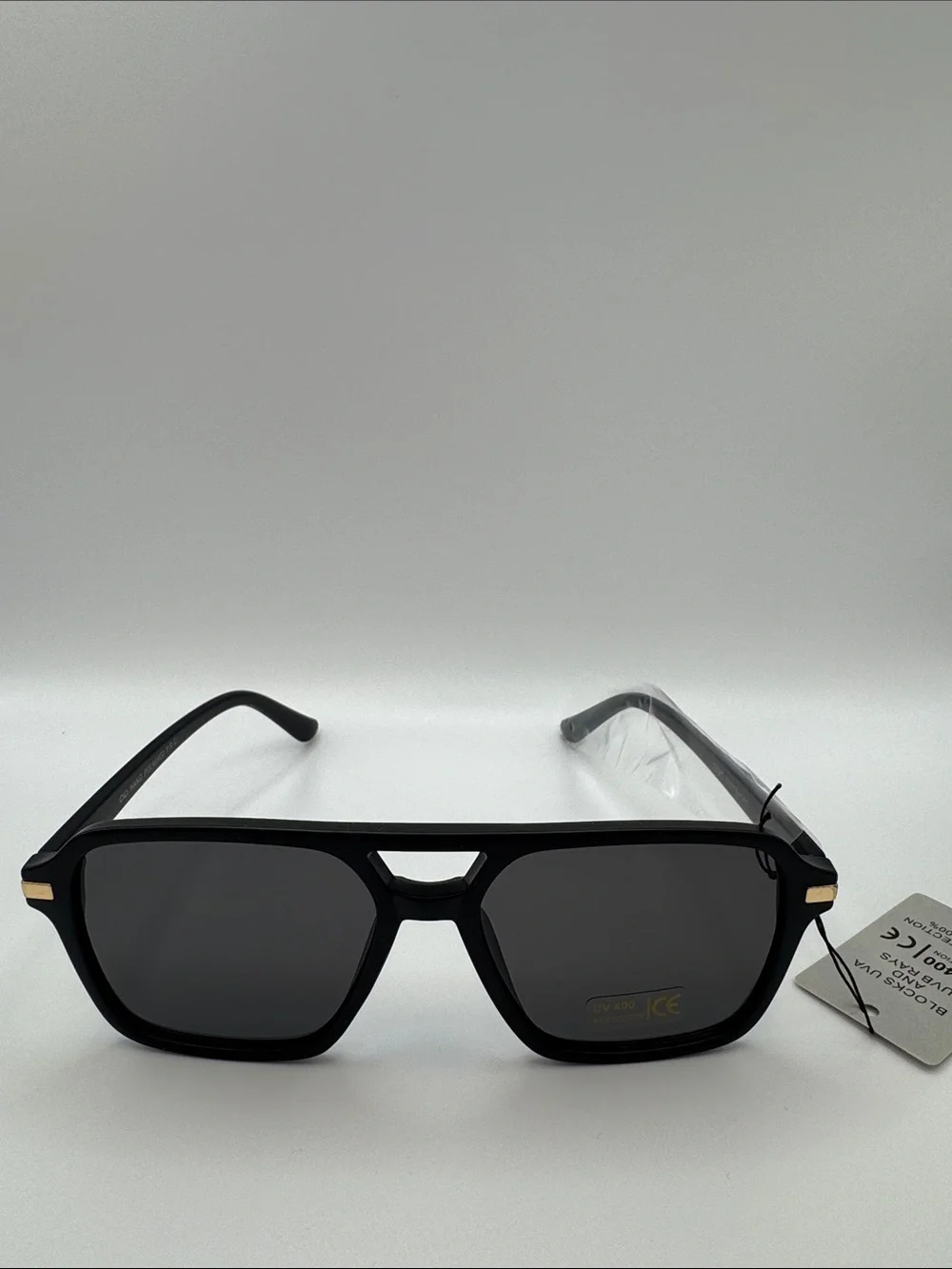 Black Sunglasses with Dark Lenses and Gold Accents
